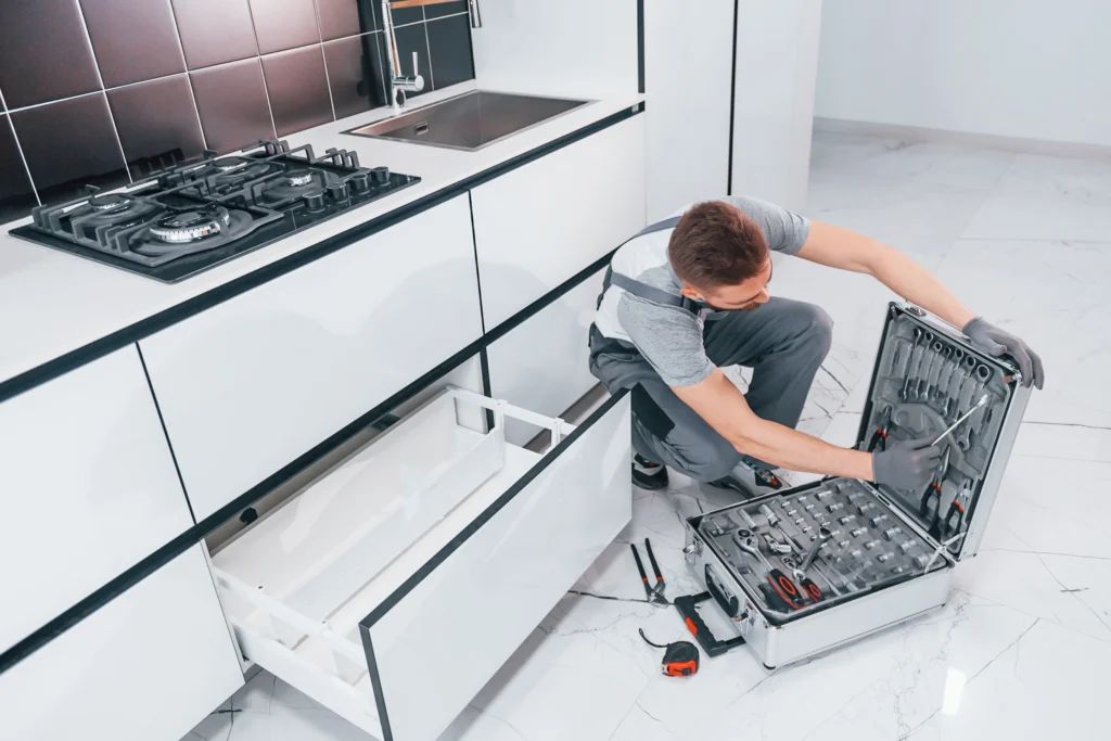 young professional plumber in grey uniform using e 1 1