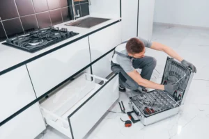 young-professional-plumber-in-grey-uniform-using-e-